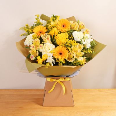 Brighten any day with our radiant Sunshine Giftbox, bursting with vibrant hues of yellow and orange flowers. Expertly handcrafted by a skilled local florist, you can buy this stunning bouquet online for same day delivery by hand. Illuminate the moment with the warmth and cheer of fresh flowers, effortlessly ordered and delivered to your doorstep. Order today online for someone special in your life this Easter.  